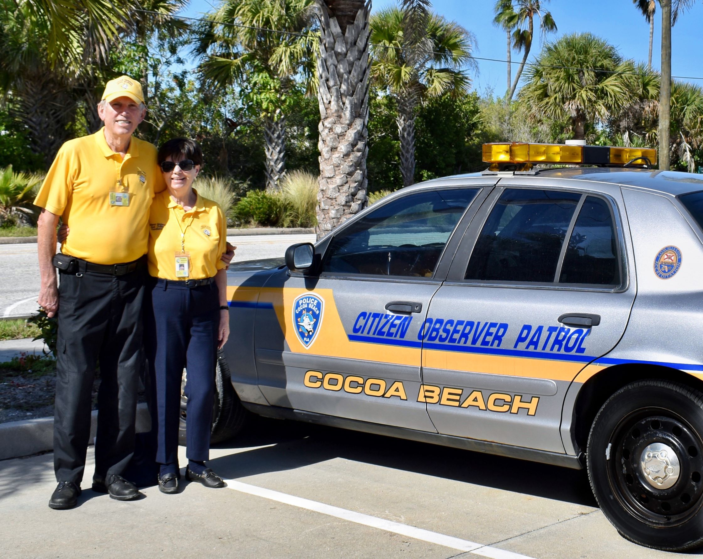 Citizen Observer Patrol car with two volunteers standing next to the vehicle